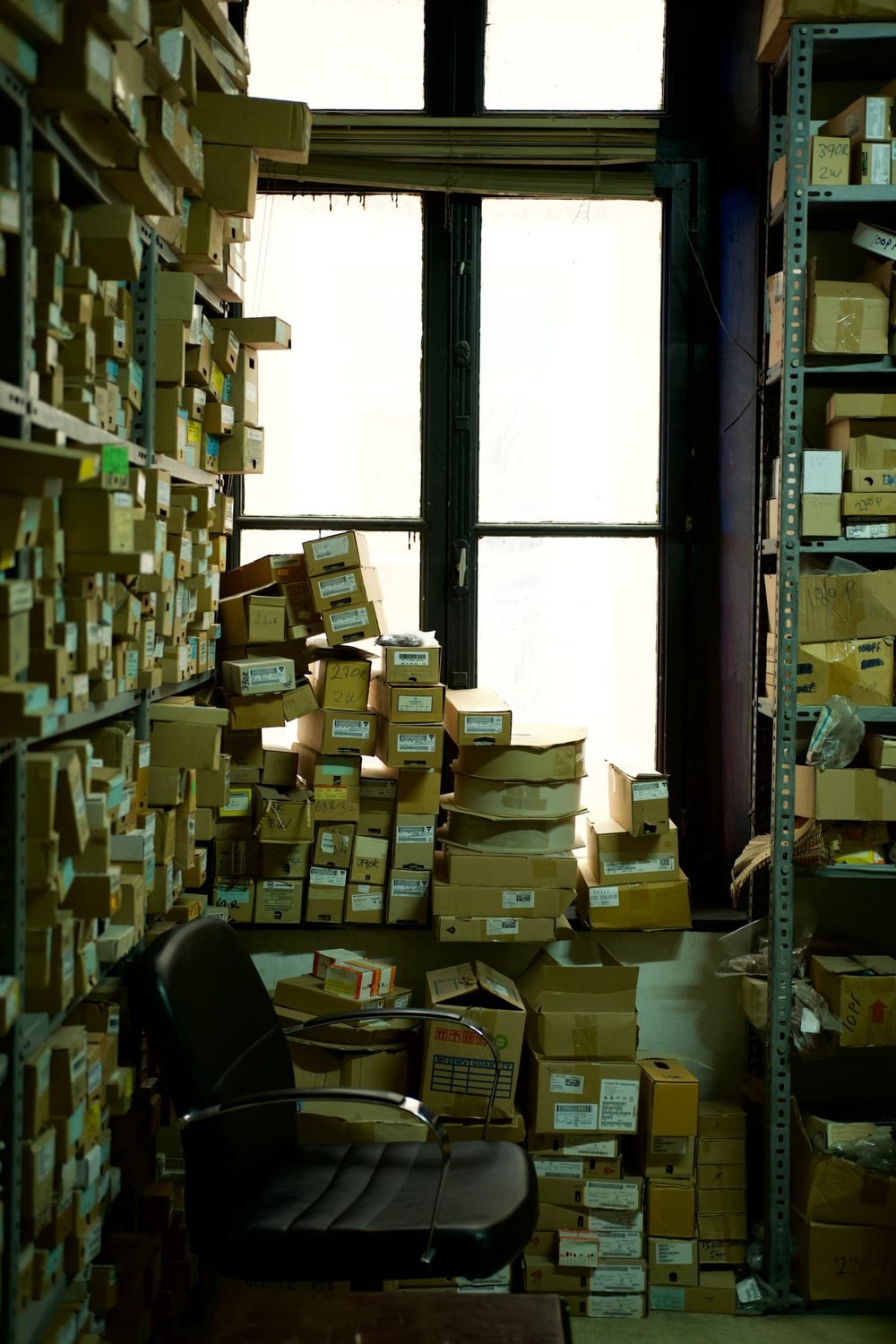 Storage room with cardboard boxes and an office chair