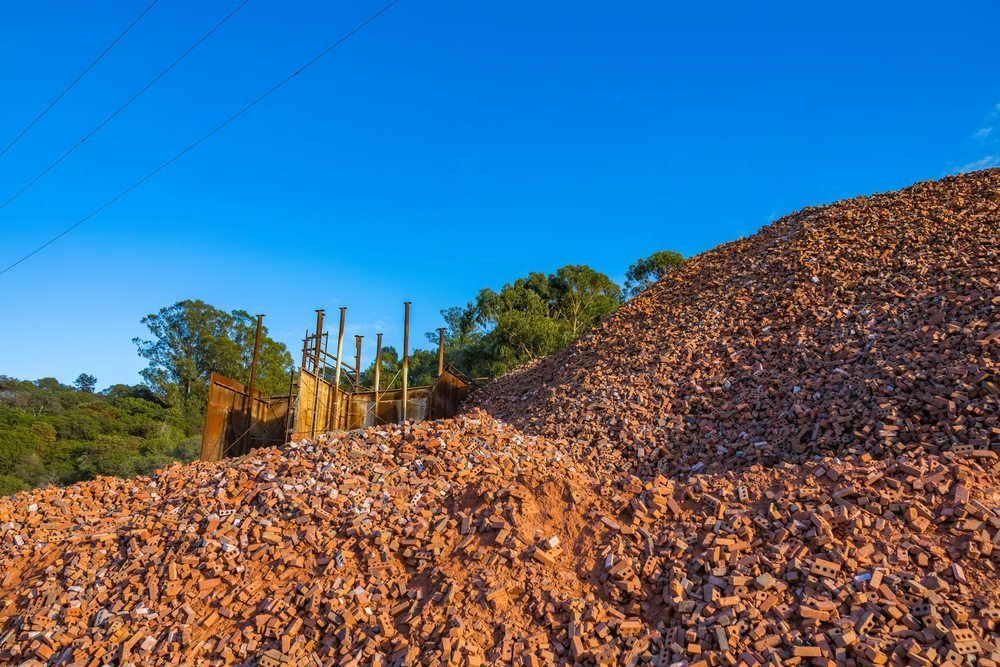 Large pile of discarded bricks at a construction material site
