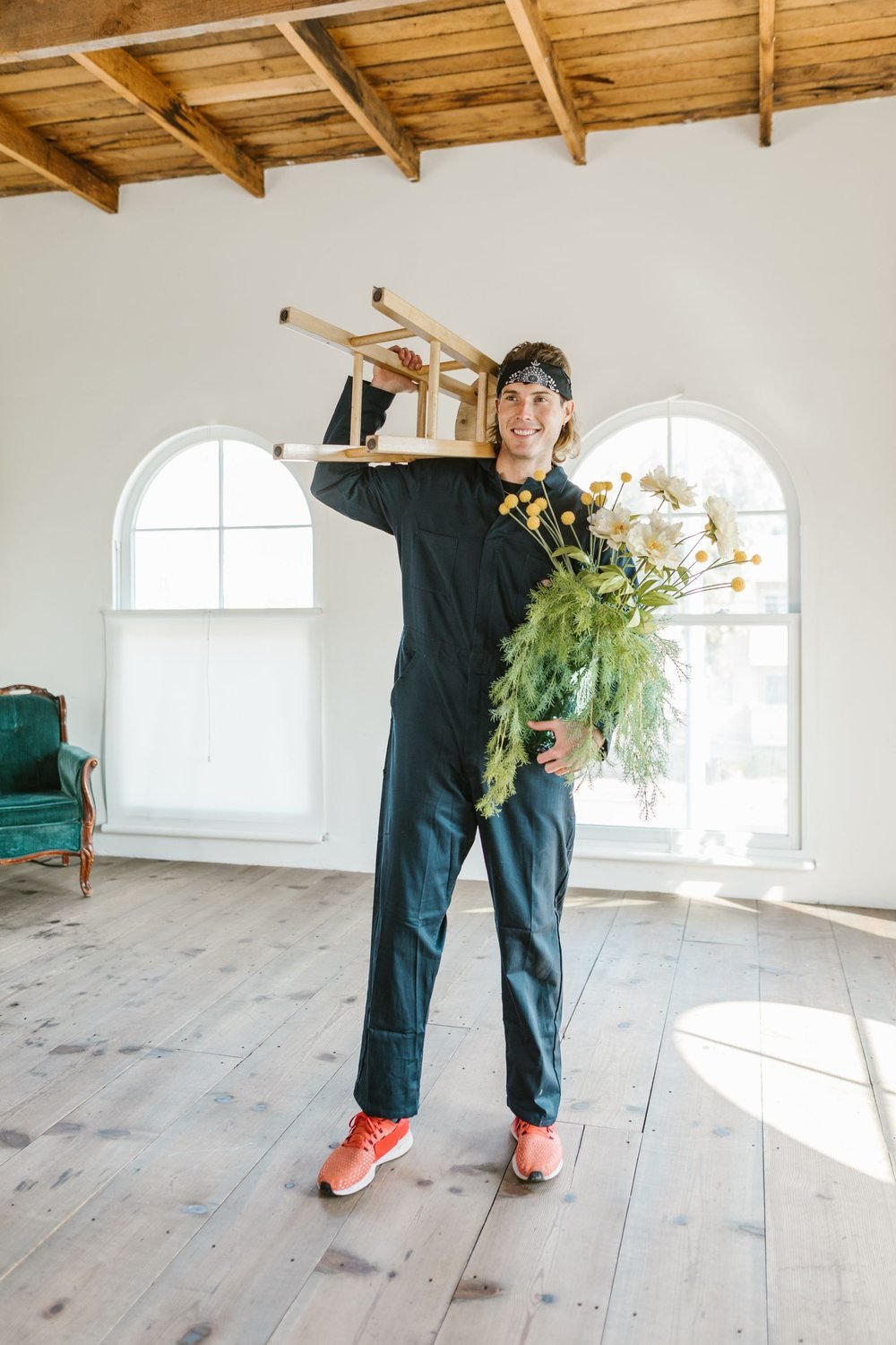 Worker carrying a wooden chair inside a home