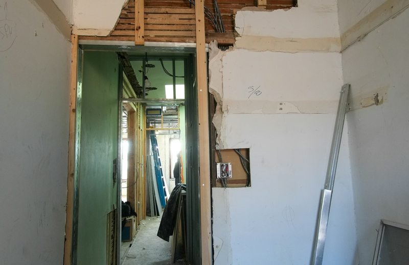 Exposed doorway and unfinished wall surfaces during interior demolition