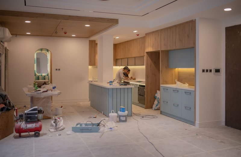 Workers and tools in a kitchen undergoing renovation